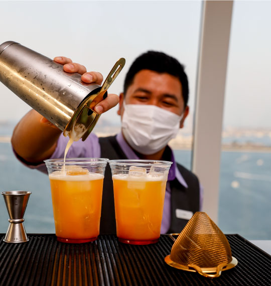 Image of bar tender pouring drinks in a skybar at Ain Dubai